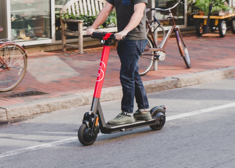 A scooter rider takes an autonomous maintenance scooter for a spin